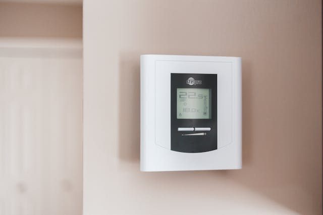 white-thermostat-hanging-on-a-wall